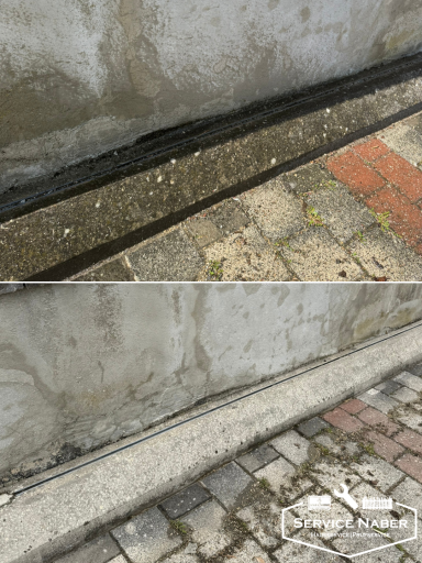 Ein schmaler Wassergraben neben einer Mauer, mit Steinen im Hintergrund. Hochdruckreinigung Amberg